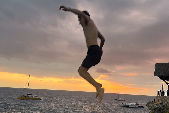 7 Mile Beach Party Catamaran Cruise with Snorkeling & Ricks Cafe - The party catamaran with DJ and unlimited rum-vodka mixes