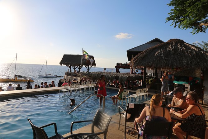 Negril 7 Mile Beach & Ricks Cafe Sunset Tour (Private ) - Rick’s Cafe at sunset: music, food, pool time, and a cliff jump option