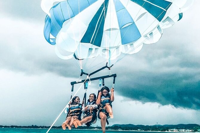 Parasailing, Blue Hole Mineral Spring, Seven Mile Beach - Puerto Seco Beach in Discovery Bay: shallow-water ease and an obstacle-course touch